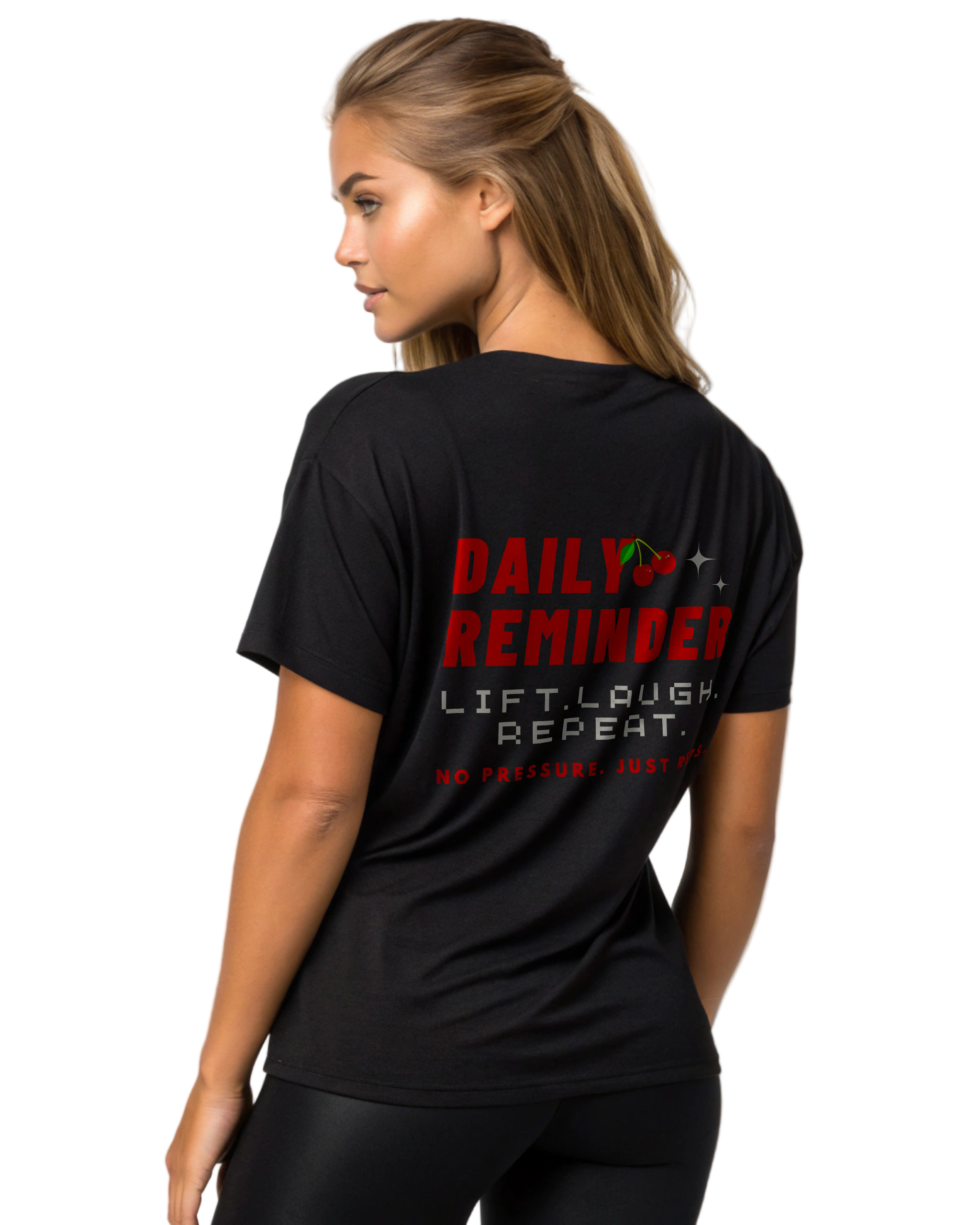 Woman wearing a black t-shirt with motivational text on the back against a plain background