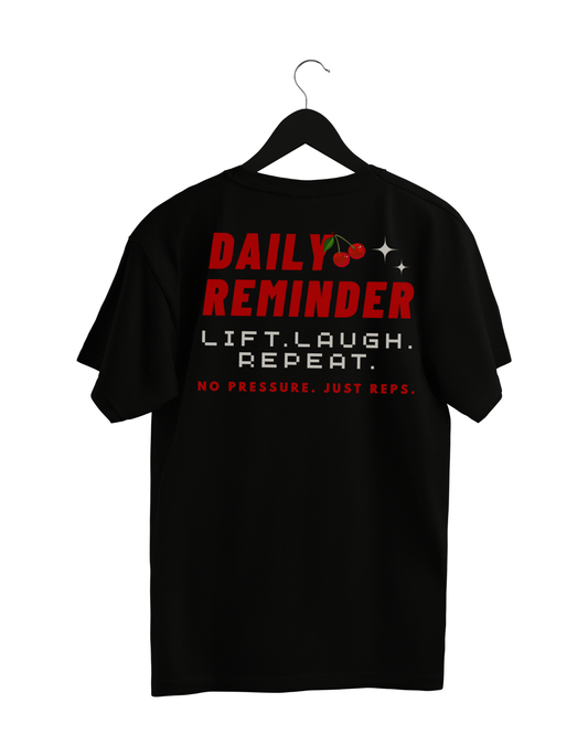 Black t-shirt with motivational text on a hanger against a white background