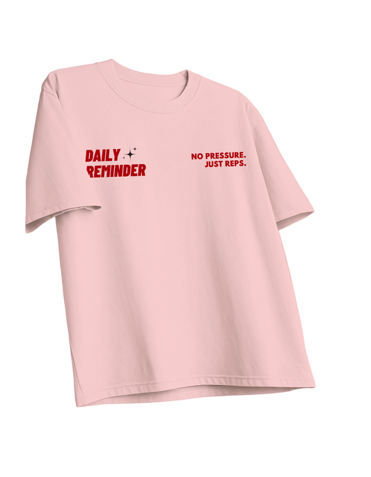 Pink t-shirt with motivational text on a pink background